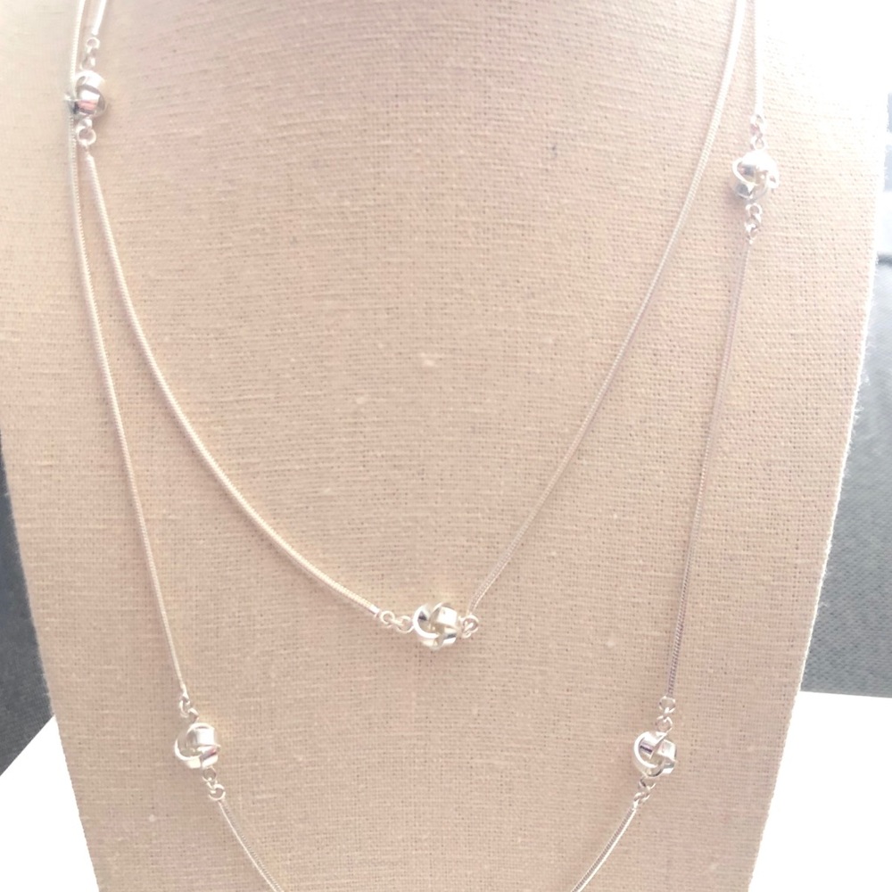 Long silver necklace with twisted accents